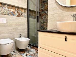 a bathroom with a toilet and a sink at Le Calette House - Puglia Mia Apartments in Monopoli