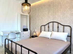 a bedroom with a large bed with white pillows at Le Calette House - Puglia Mia Apartments in Monopoli