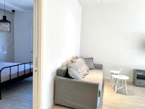 a living room with a couch and a table at Le Calette House - Puglia Mia Apartments in Monopoli