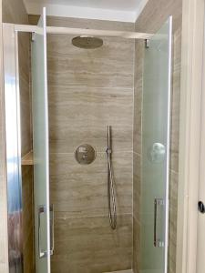 a shower with a glass door in a bathroom at Le Calette House - Puglia Mia Apartments in Monopoli
