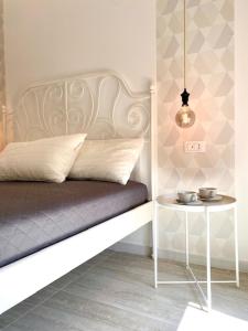a room with a bed and a side table at Le Calette House - Puglia Mia Apartments in Monopoli