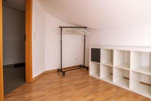 a room with white shelves and a closet at Appartement 5 in Hilter in Hilter am Teutoburger Wald