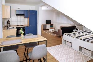 a living room with a kitchen and a dining room at Appartement 5 in Hilter in Hilter am Teutoburger Wald