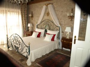 a bedroom with a white bed with red pillows at Villa-Angelina in Langenzersdorf