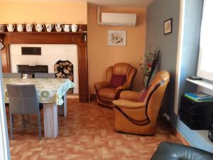 a living room with two chairs and a table at Gite Des Croix Bancaud in Jumilhac-le-Grand