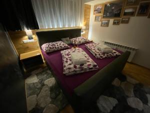 a bedroom with two beds with purple sheets at Luxury Apartments Ostrava in Ostrava