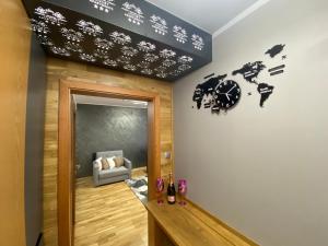a room with a wall with a clock on the wall at Luxury Apartments Ostrava in Ostrava