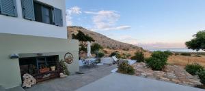 a building with a patio with a view of the ocean at Domatia me Thea in Elafonisos