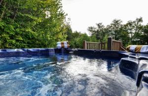 a swimming pool in a yard with trees at Chalets Alpins - 56 Chemin des Skieurs in Stoneham