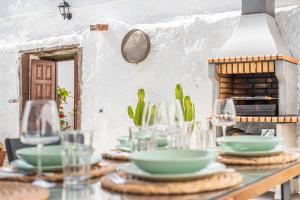 una mesa con platos y vasos. en La Huertita de Arona Tenerifesummervillas, en Arona