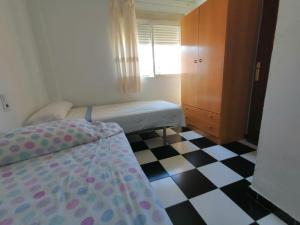 Łóżko lub łóżka w pokoju w obiekcie Apartamento Juan Bautista
