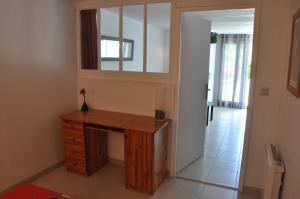 a room with a wooden desk and a mirror at La Bourgeat in Chantesse
