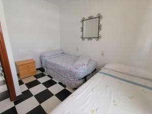 Łóżko lub łóżka w pokoju w obiekcie Apartamento Juan Bautista