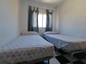 Łóżko lub łóżka w pokoju w obiekcie Apartamento Juan Bautista