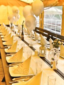 a long table with plates and napkins on it at Karczma Kubalonka in Istebna