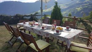 a table with food on it with a view of a mountain at HOME SWEET HOME in Antey-Saint-André