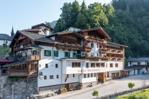 a large white building with a sign on it at Bed & Breakfast Hotel Märzenklamm in Stumm