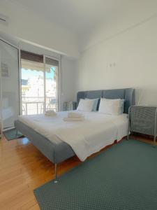 a bedroom with a large bed with white sheets at Acropolis Exceptional View II in Athens
