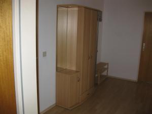 a wooden cabinet in the corner of a room at Haus Weißbrod in Essingen