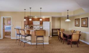 a kitchen and dining room with a table and chairs at Club Wyndham Bonnet Creek Resort with Disney shuttles and near Universal Studios in Orlando