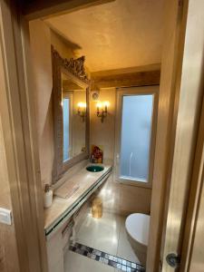 a bathroom with a sink and a toilet and a mirror at La Petite Sirène in Trouville-sur-Mer +22 photos
