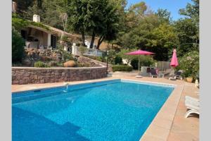 a swimming pool in front of a house at Villa Provençale Le Mas Busien in La Motte