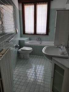 a bathroom with a tub and a toilet and a sink at Casa Cavour in Pesaro +9 photos