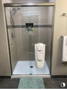 a shower with a glass door in a bathroom at Trendy Midtown Lofts in Cleveland