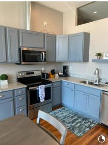 a kitchen with blue cabinets and a sink at Trendy Midtown Lofts in Cleveland