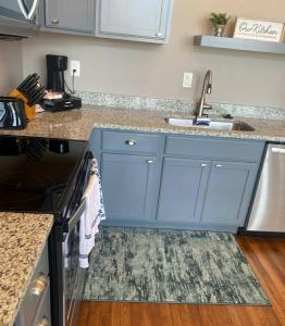 a kitchen with blue cabinets and a sink at Trendy Midtown Lofts in Cleveland