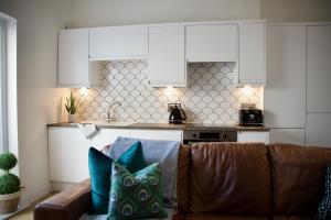 a living room with a couch and a kitchen at The Dunes in Redcar