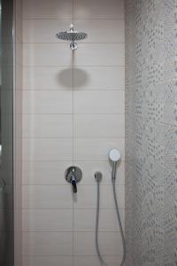 a shower with a shower head in a bathroom at Hana - Apartments in Ljubljana