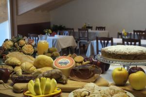 a table topped with lots of different types of food at Agriturismo Casa Preti in Revò