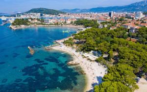 an aerial view of a beach and a city at Beach Villa Apartment on top location, with pool, sea view and exotic garden in Split