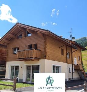 a building with a sign in front of it at AG Apartments Livigno centro in Livigno