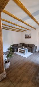 a living room with a couch and a table at Ferienwohnung Spessartbude in Schollbrunn