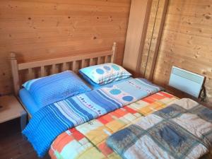 a bed with two pillows on it in a room at Chalet Kovačević in Žabljak