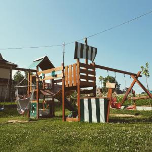 a playground with a slide and a swing at Kłabuk in Białka Tatrzanska