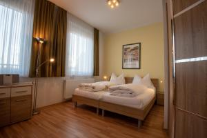 Posteľ alebo postele v izbe v ubytovaní City Appartements Weiz