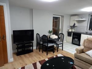 a living room with a television and a table with chairs at Login house A in Derry Londonderry