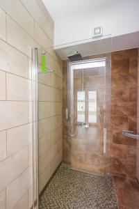 a bathroom with a shower with a glass door at Danubiana Apartments 5 in Kladovo