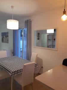 uma cozinha e sala de jantar com mesa e cadeiras em Casa Azul em Porto Santo