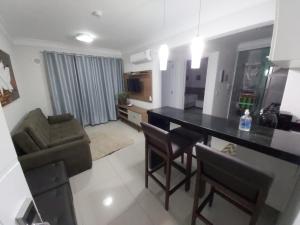 a kitchen and living room with a table and chairs at Apartamento Bombinhas Summer Beach in Bombinhas