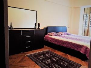 a bedroom with two beds and a dresser and a mirror at Spacious and Cozy in Tashkent +1 photo