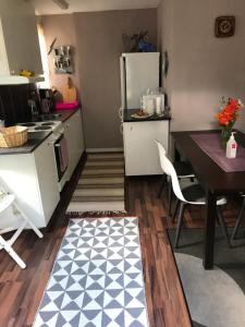 a small kitchen with a table and a refrigerator at Vacker hus i naturen in Fröseke +19 photos
