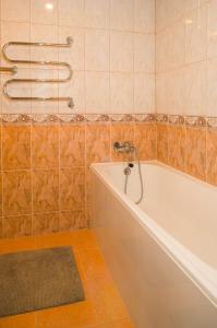 a bathroom with a tub and a shower at Laurentroom Townhouse in Ukmergė +15 photos