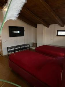 a living room with a red couch and a tv at Residence Garibaldi bilocale e monolocale in centro a Foligno terzo e quarto piano in Foligno