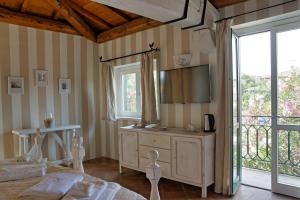 a bedroom with a tv and a bed and a window at Domus Corallia-Luxury Rooms in Porto Rotondo