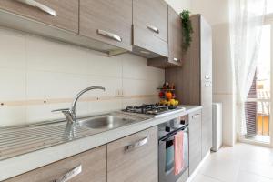 a kitchen with a sink and a stove at Leonardo Suite Navona in Rome