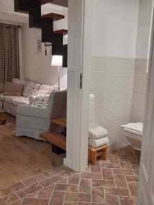 a living room with a couch and a bathroom at BABIE LATO dostęp do jeziora UBLIK in Konopki Wielkie +111 photos